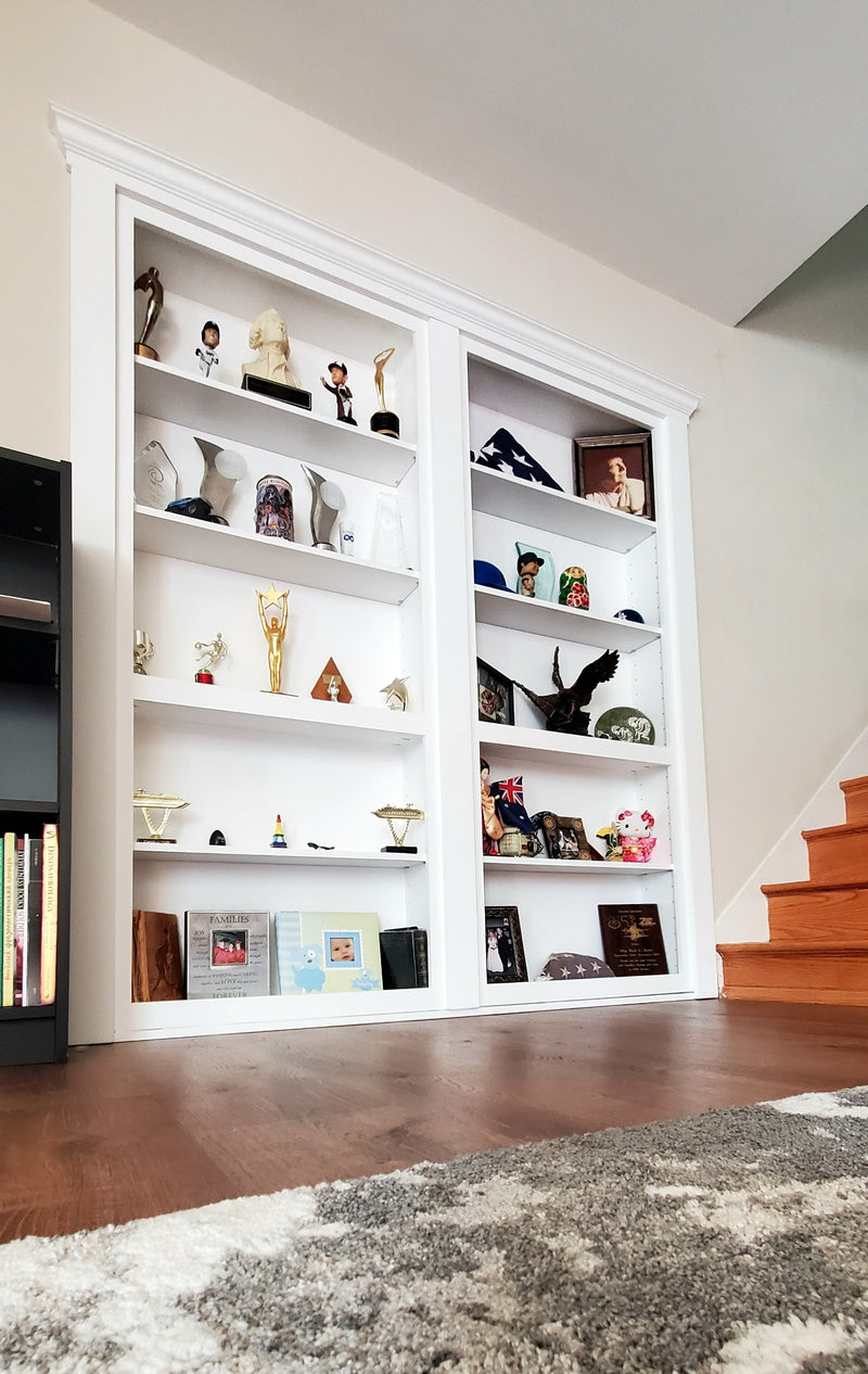 double bookcase door painted white with crown molding